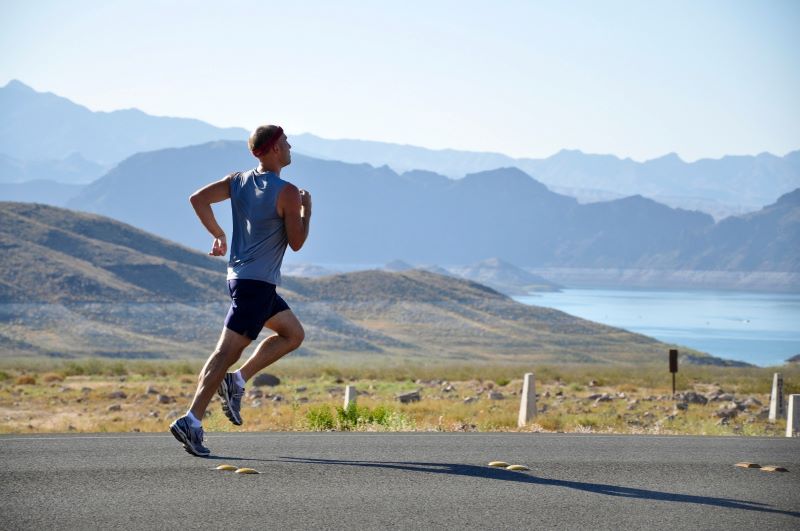 A man running in the mountains while wearing sportswear