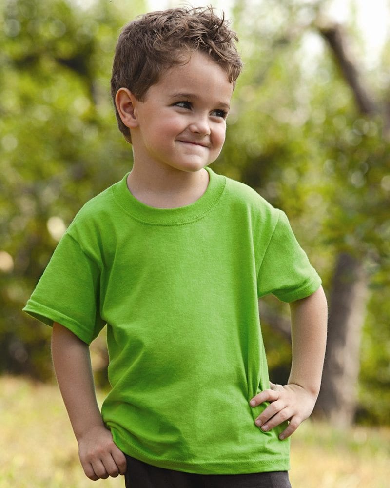 A boy in nature wearing a green t-shirt