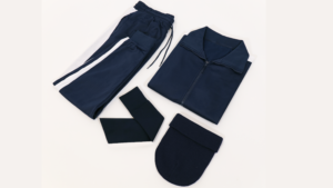 A navy-colored set of exercising gear - beanie, scarf, sweat pants, and zip-up