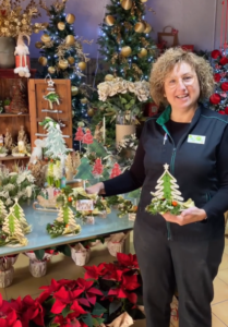 Montse stands proudly next to the wares of her store