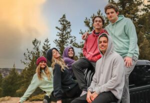 A group of young people in nature, all wearing blank hoodies