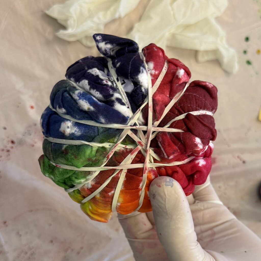 A t-shirt in a ball, dyed in the colors of the rainbow