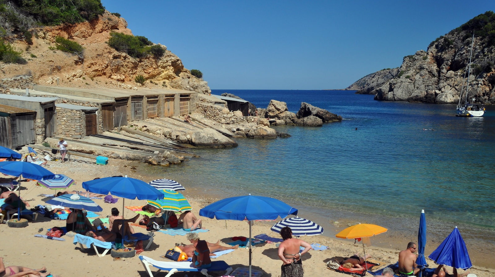 Groups of people on a beach at a cove