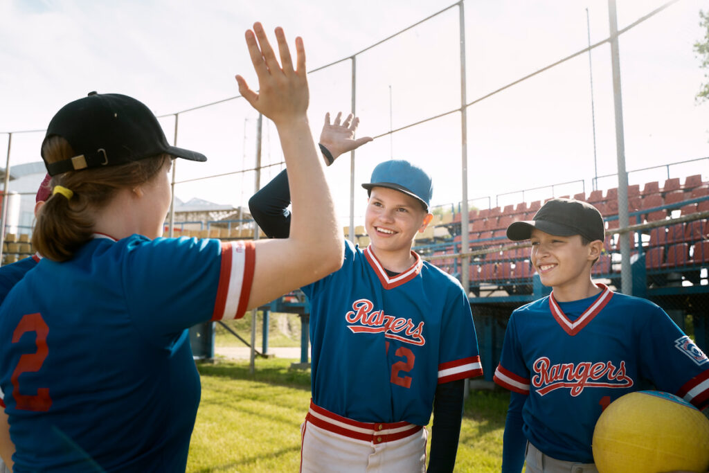 Children in uniforms during a baseball game